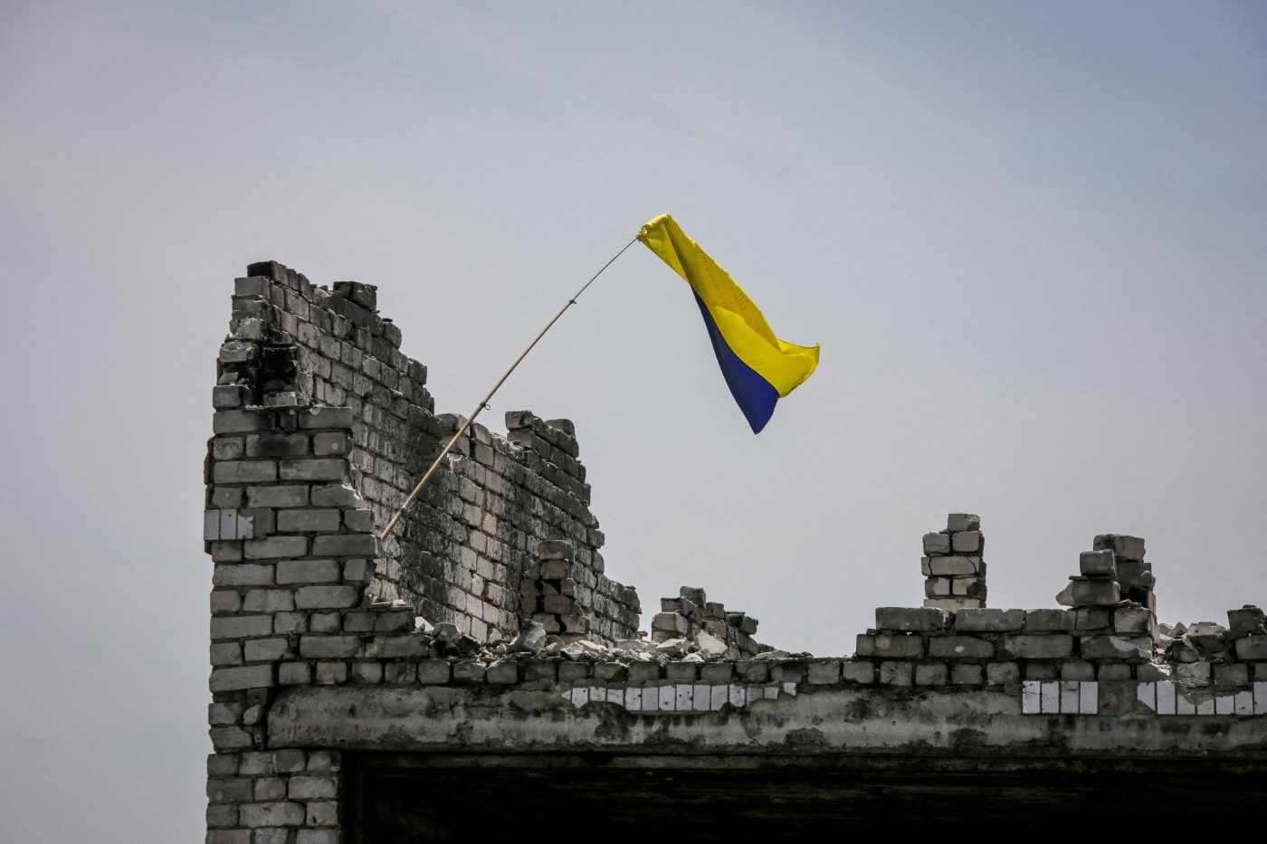 Photo: A Ukrainian national flag is seen, amid Russia's attack on Ukraine, near the front line in the newly liberated village Neskuchne in Donetsk region, Ukraine June 13, 2023. Credit: REUTERS/Oleksandr Ratushniak