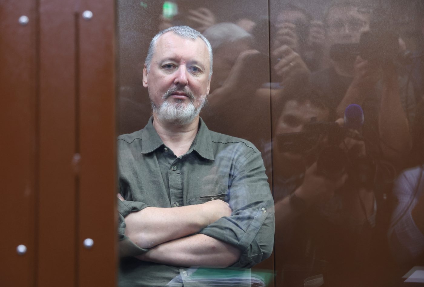 Photo: Russian nationalist Kremlin critic and former military commander Igor Girkin, also known as Igor Strelkov, who is charged with inciting extremist activity, sits behind a glass wall of an enclosure for defendants before a court hearing in Moscow, Russia, July 21, 2023. Credit: REUTERS/Yulia Morozova