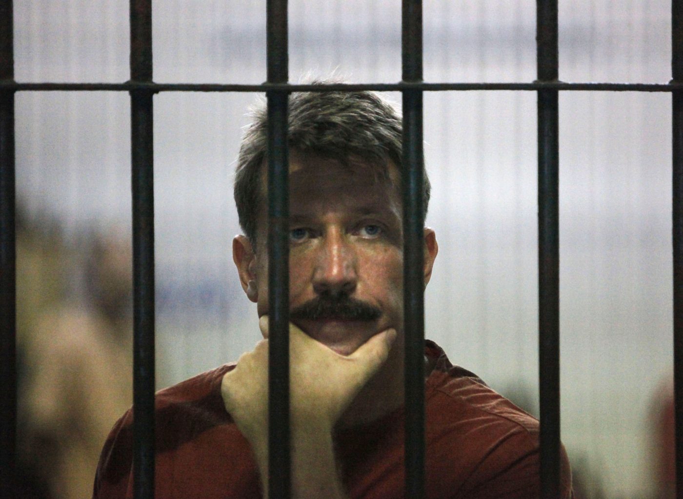 Photo: Suspected Russian arms dealer Viktor Bout waits in a holding cell after arriving for an extradition hearing at the criminal courthouse in Bangkok March 9, 2009. Bout said the United States had no proof linking him to weapons sales to Colombian rebels, as a Thai court adjourned an extradition hearing because his wife was to too ill to testify. Credit: REUTERS/Sukree Sukplang (THAILAND POLITICS CONFLICT SOCIETY)