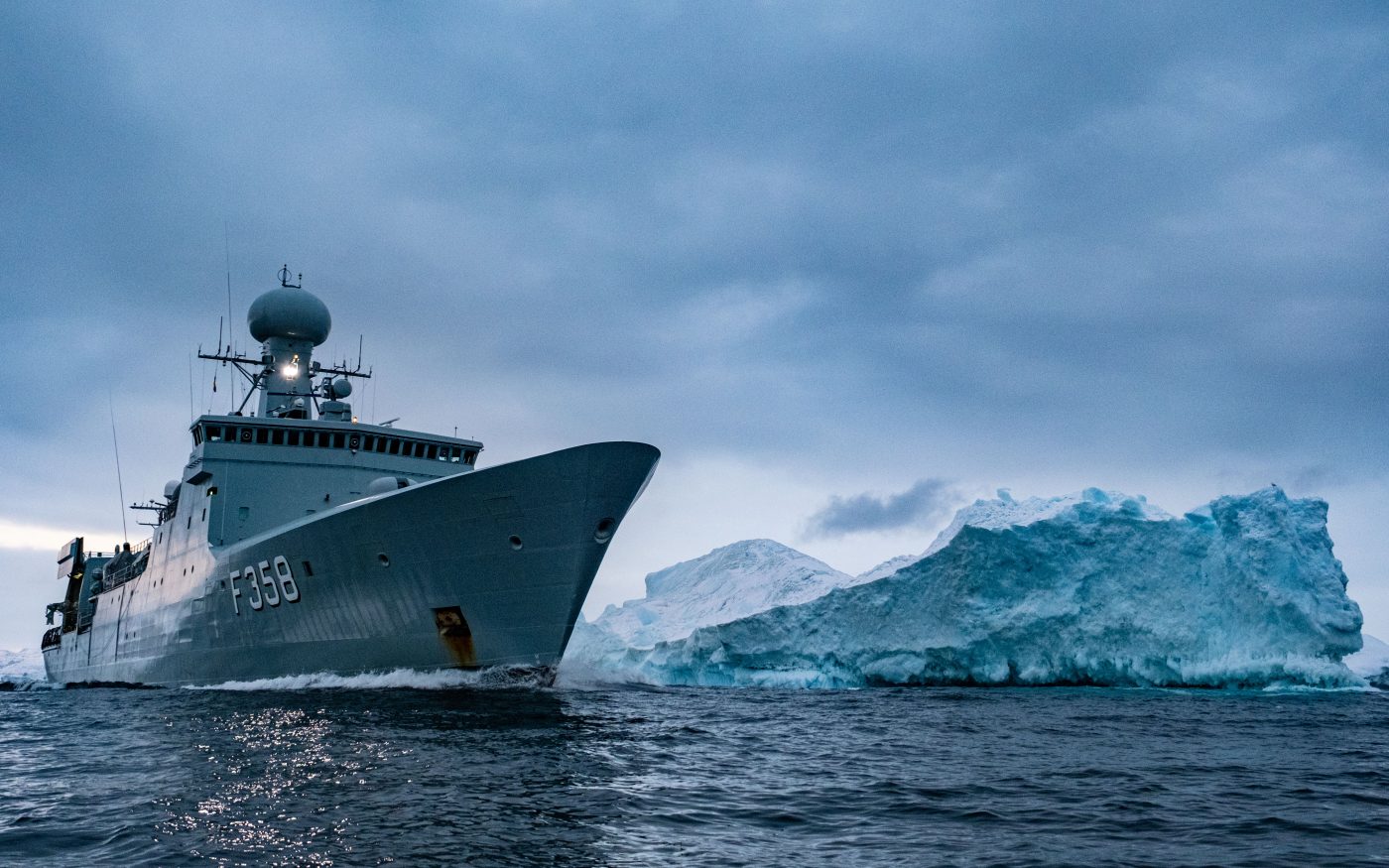 Photo: The Royal Danish Navy frigate HDMS Triton passes an iceberg in the waters around Greenland. The Royal Danish Navy frigate HDMS Triton is part of the Joint Arctic Command Denmark., Credit: NATO via Flickr. https://flic.kr/p/2ojtpyS