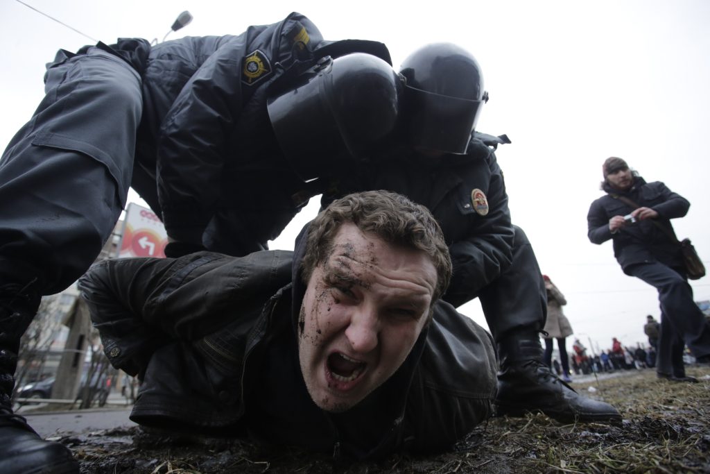 Photo: Interior Ministry members detain a man during a protest rally held by opposition activists and members of the Other Russia movement in St. Petersburg, February 15, 2014. Participants demanded to abolish the results of the privatization of the Russian state property and primary resources which took place in the nineties and protested against plans by authorities for further privatization, according to organizers. Credit: REUTERS/Maxim Zmeyev