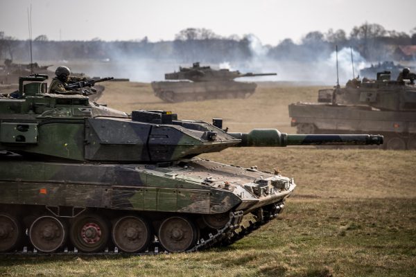 Photo: Swedish Army Leopard tanks crossing open ground during Exercise Aurora 23. Credit: NATO via Flickr. https://flic.kr/p/2oAzS42