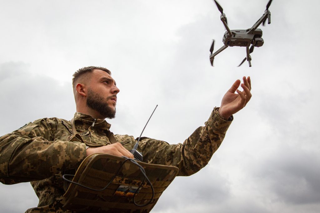 Photo: A serviceman launches a drone during a press tour set to demonstrate the integration of AI into the process of humanitarian demining, Zhytomyr Region, northern Ukraine. Credit: Kirill Chubotin/Ukrinform/Sipa USA.