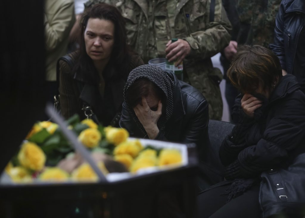Photo: Mourners grieve at the coffin of Rodion Dobrodomov, a member of the Ukrainian National guard killed during a pitched battle in Mariupol on Friday, at his funeral in Kiev May 12, 2014. Ukrainian forces drove pro-Russian rebels from police headquarters in the eastern city of Mariupol on Friday in a pitched battle, killing 20 of them, the country's Interior Ministry said. Credit: REUTERS/Konstantin Grishin