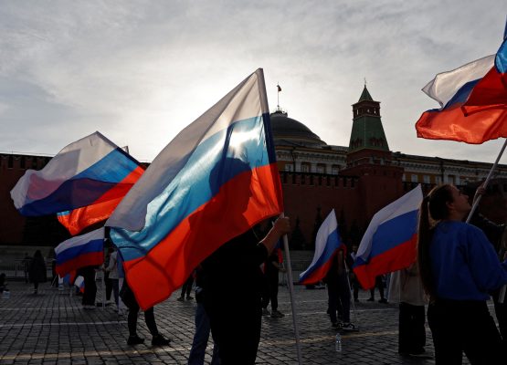Photo: People hold Russian flags in Red Square before a rally to mark the one-year anniversary of Russia's annexation of four regions in Ukraine, in Moscow, Russia September 29, 2023. Credit: REUTERS/Stringer