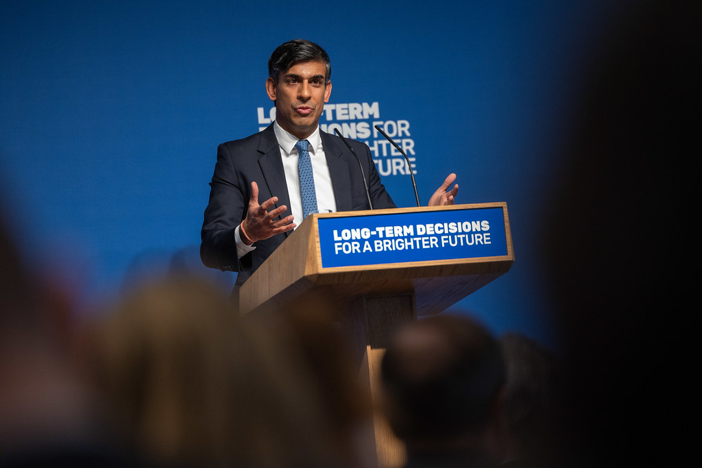 Photo: British Prime Minister Rishi Sunak delivers a speech on AI at Royal Society, Carlton House Terrace on October 26, 2023 in London, England. Credit: @rishisunak via Twitter. https://twitter.com/RishiSunak/status/1717926850133954987/photo/1