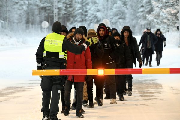 Photo: Finnish Border Guard speaks to the migrants at the international border crossing at Salla, northern Finland, November 23, 2023. Credit: Lehtikuva/Jussi Nukari via REUTERS.