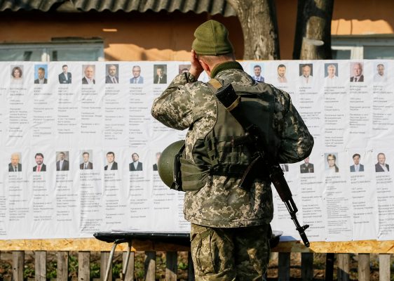 Photo: A Ukrainian serviceman reads information about presidential candidates at a polling station, created for the servicemen who take part in the government's five-year-old conflict in eastern Ukraine against Kremlin-backed rebels, near the front line, during a presidential election in the village of Zaitseve, Ukraine March 31, 2019. Credit: REUTERS/Gleb Garanich TPX IMAGES OF THE DAY