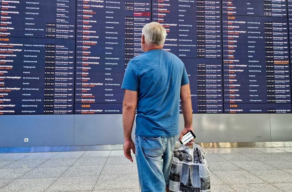 Photo: A man looks at a flight information board at a terminal of the Sheremetyevo international airport outside Moscow, Russia, August 23, 2023. Credit: REUTERS/Maxim Shemetov.