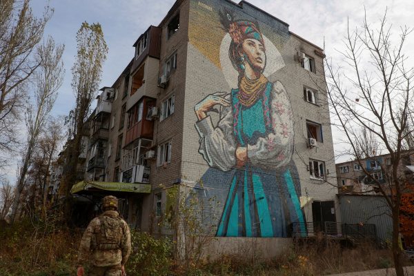 Photo: A Ukrainian serviceman walks next to a residential building heavily damaged by permanent Russian military strikes in the front line town of Avdiivka, amid Russia's attack on Ukraine, in Donetsk region, Ukraine November 8, 2023. Credit: Radio Free Europe/Radio Liberty/Serhii Nuzhnenko via REUTERS