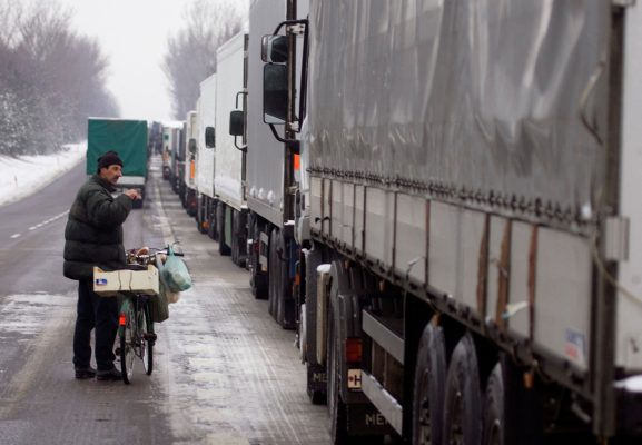 PHOTO: A man offers food for sale to lorry drivers held up because of striking customs officers near Kukuryki at the Polish-Belarus border, some 200 km (124.3 miles) east of Warsaw, January 29, 2008. Polish lorry drivers delayed until Tuesday their planned blockade of Warsaw in protest at delays at the country's borders caused by striking customs officers, the truckers' union chief said. Credit: REUTERS/Vasily Fedosenko (POLAND)/File Photo