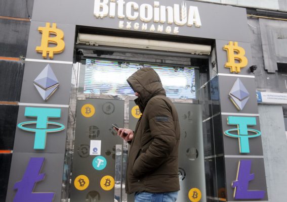 Photo: A man walks past a cryptocurrency exchange point in the center of Kyiv, Ukraine on 24 January 2022. Bitcoin dropped below $34 000, to six-month low, as fears of war in Ukraine shake stock markets, according to media. Credit: (Photo by STR/NurPhoto)NO USE FRANCE