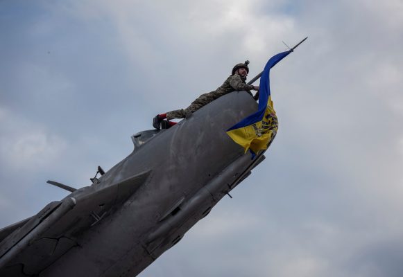 Photo: A Ukrainian serviceman installs a Ukrainian national flag on a decommissioned fighter plane converted to a monument, amid Russia's attack on Ukraine, in Bakhmut, Donetsk region, Ukraine January 19, 2023. Credit: REUTERS/Oleksandr Ratushniak