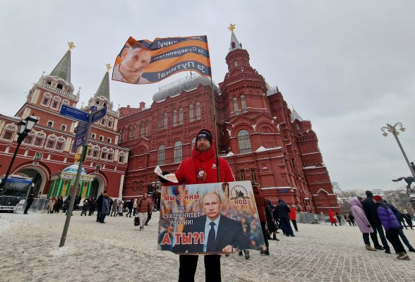 Photo: A supporter of Russian President Vladimir Putin distributes newspapers on the first anniversary of the beginning of Russia's military campaign in Ukraine, near the State Historical Museum in central Moscow, Russia, February 24, 2023. A slogan on the board reads: "He and I are for sovereignty of Russia! And you?" Credit: REUTERS/Shamil Zhumatov