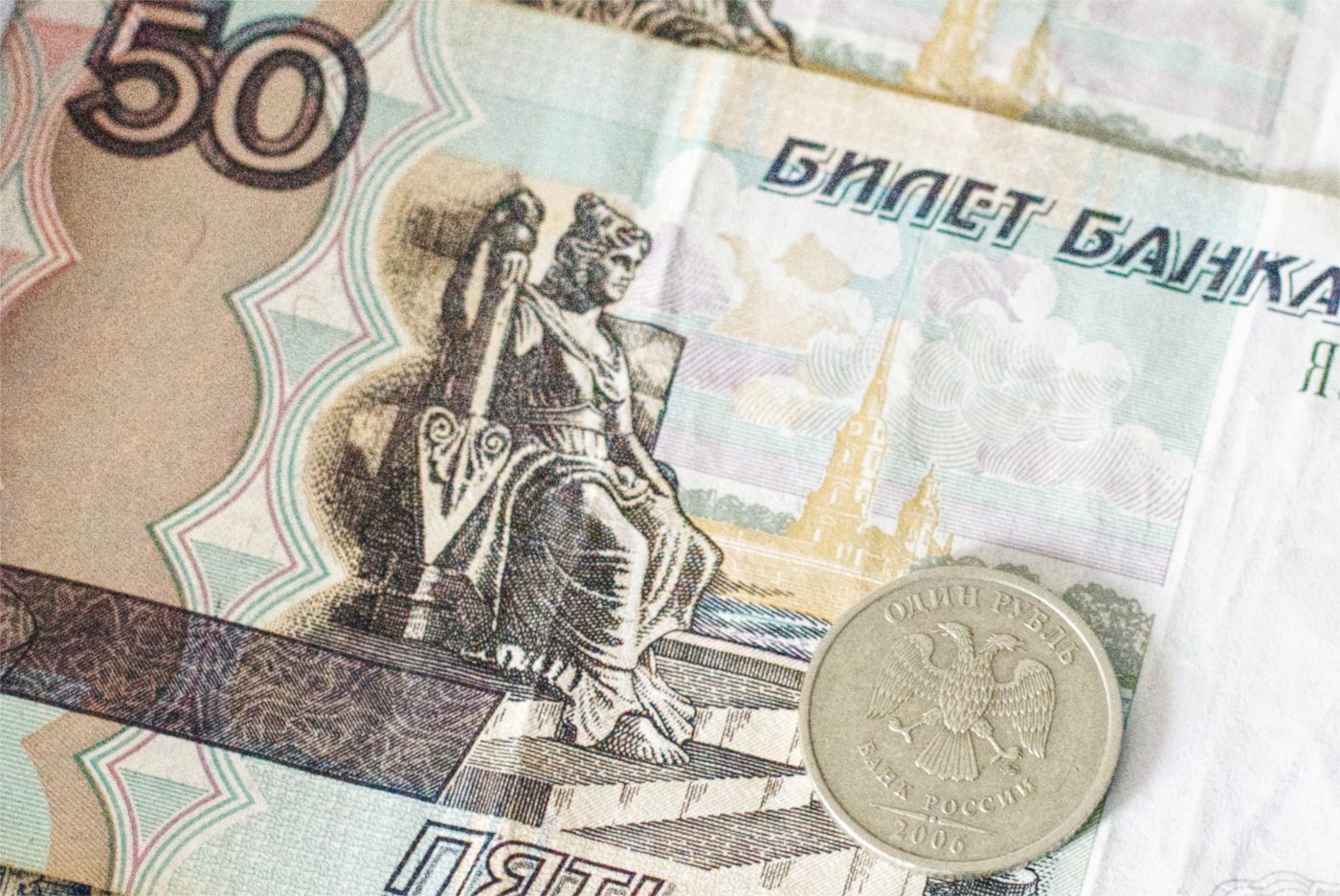 Photo: A 1 ruble coin and 50 ruble banknote in the background. Illustration of the currency of the Russian Federation, the Ruble (RUB). Credit: Benjamin Furst / Hans Lucas via Reuters Connect.
