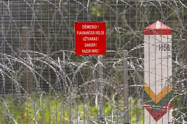 Photo: Sign "Razor Wire" and Lithuanian border pole is seen on Belarus border in Kaniukai, Lithuania July 7, 2023. Credit: REUTERS/Janis Laizans