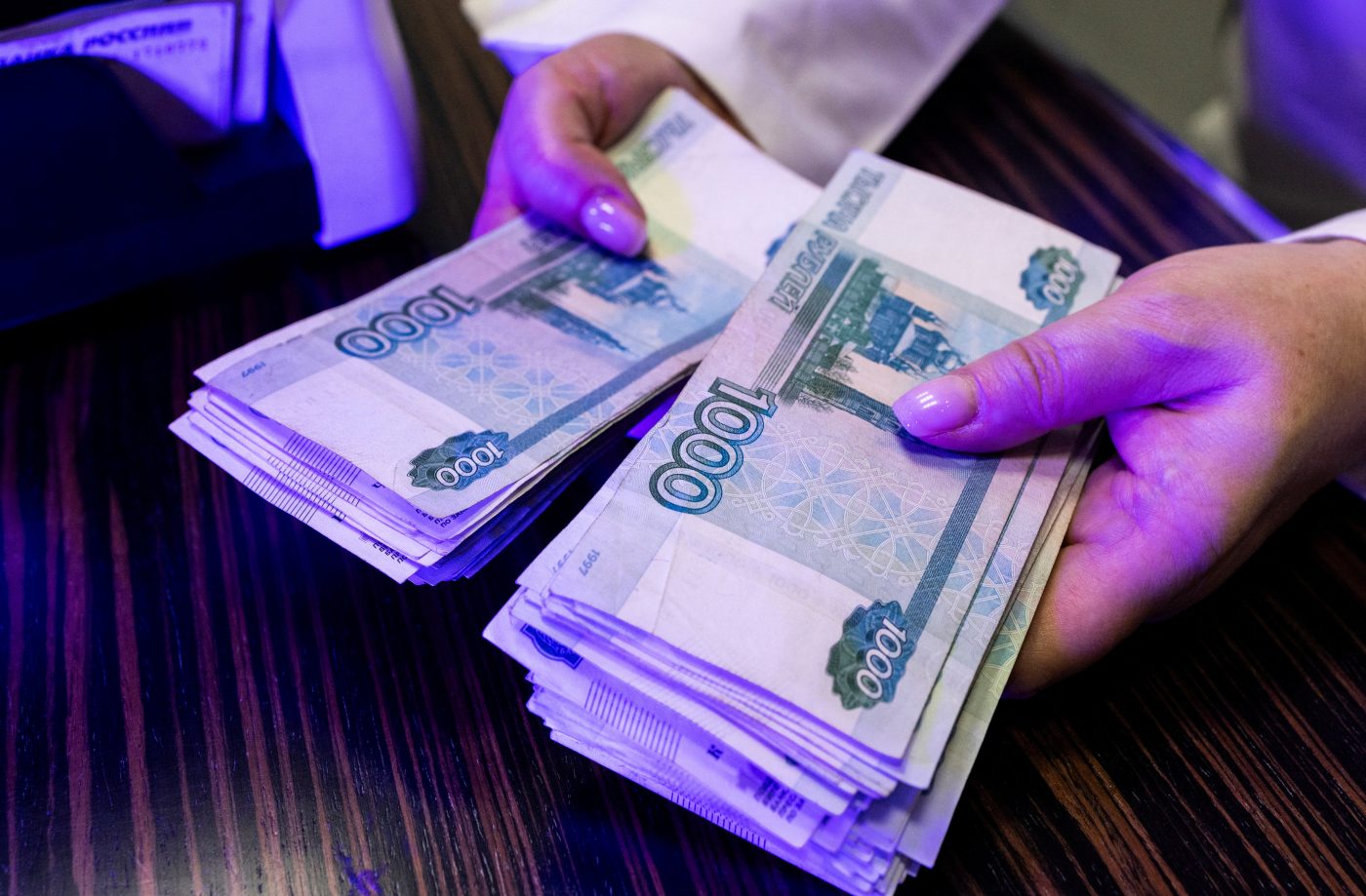 Photo: An employee holds Russian 1000-rouble banknotes in a bank office in Moscow, Russia, in this illustration picture taken October 9, 2023. Credit: REUTERS/Maxim Shemetov/Illustration