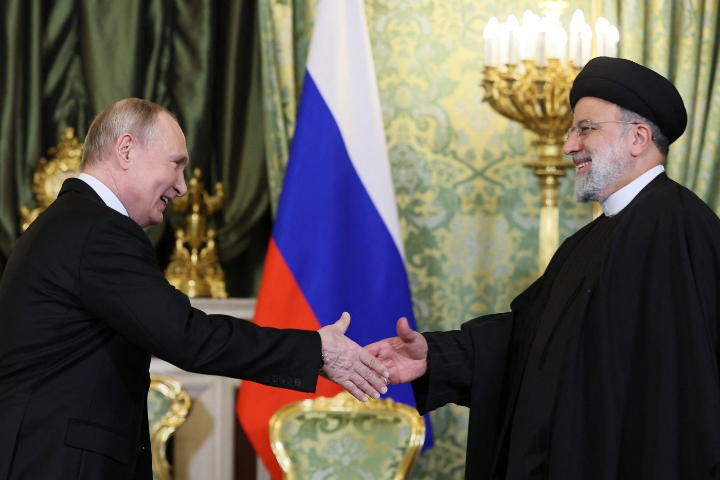 Photo: Russian President Vladimir Putin shakes hands with Iranian President Ebrahim Raisi during a meeting in Moscow, Russia December 7, 2023. Credit: Sputnik/Sergei Bobylev/Pool via REUTERS