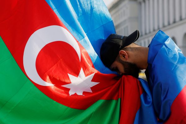 Photo: A member of Azerbaijan diaspora kisses Azerbaijan's national flag during a rally in support of his country over the conflict in the Nagorno-Karabakh region, at the Independence Square in Kyiv, Ukraine October 11, 2020. Credit: REUTERS/Valentyn Ogirenko