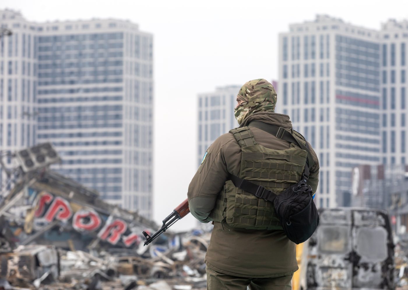 Photo: A soldier with a machine gun is on duty near the destroyed Retroville shopping center. Retroville shopping center including its surrounding areas in Kyiv are destroyed after the Russian shelling attack. According to the emergency service, at least six people died during the attack. Russia invaded Ukraine on 24 February 2022, triggering the largest military attack in Europe since World War II. Credit: Mykhaylo Palinchak / SOPA Images/Sipa USA.