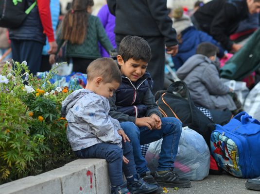 Photo: Children sit on a curb as residents gather in central Stepanakert to leave Nagorno-Karabakh, a region inhabited by ethnic Armenians, September 25, 2023. Credit: REUTERS/David Ghahramanyan