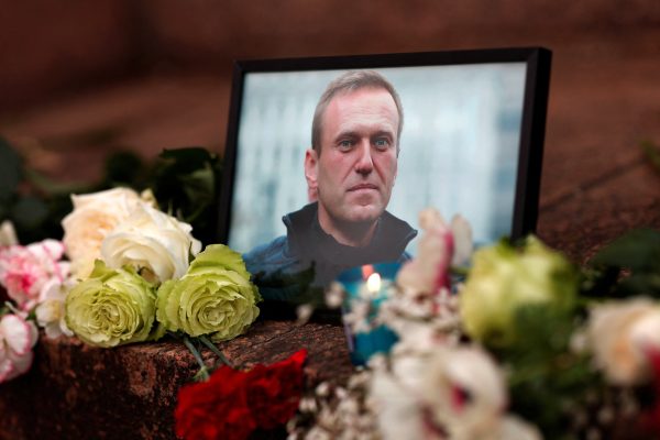 Photo: Flowers and a candle are placed next to a portrait of Russian opposition leader Alexei Navalny following Navalny's death as people gather near the Russian embassy, in Paris, France, February 16, 2024. Credit: REUTERS/Gonzalo Fuentes