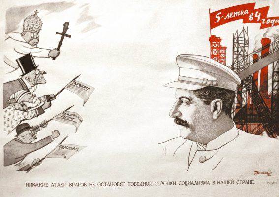 Photo: ‘No enemy attack will halt the victorious construction of socialism in our country’ — Soviet poster (1931) showing Stalin standing steadfast against counterrevolutionaries, among whom are a priest/the Pope, a social democrat, a Menshevik and a Trotskyite. Text on the factory’s flags reads: ‘The Five-Year Plan in Four Years’. Text on the flags reads: 'Forward' (in reference to the Social Democratic newspaper Vorwärts), 'Menshevik Bulletin' and just 'Falsehoods'. The poster was issued by the State Publishing House of the Russian Soviet Federative Socialist Republic and designed by Viktor Deni, one of the most prominent propagandists of the early Soviet Union. Credit: @propagandopolis via Instagram. https://www.instagram.com/p/Cpf9lByIM6z/