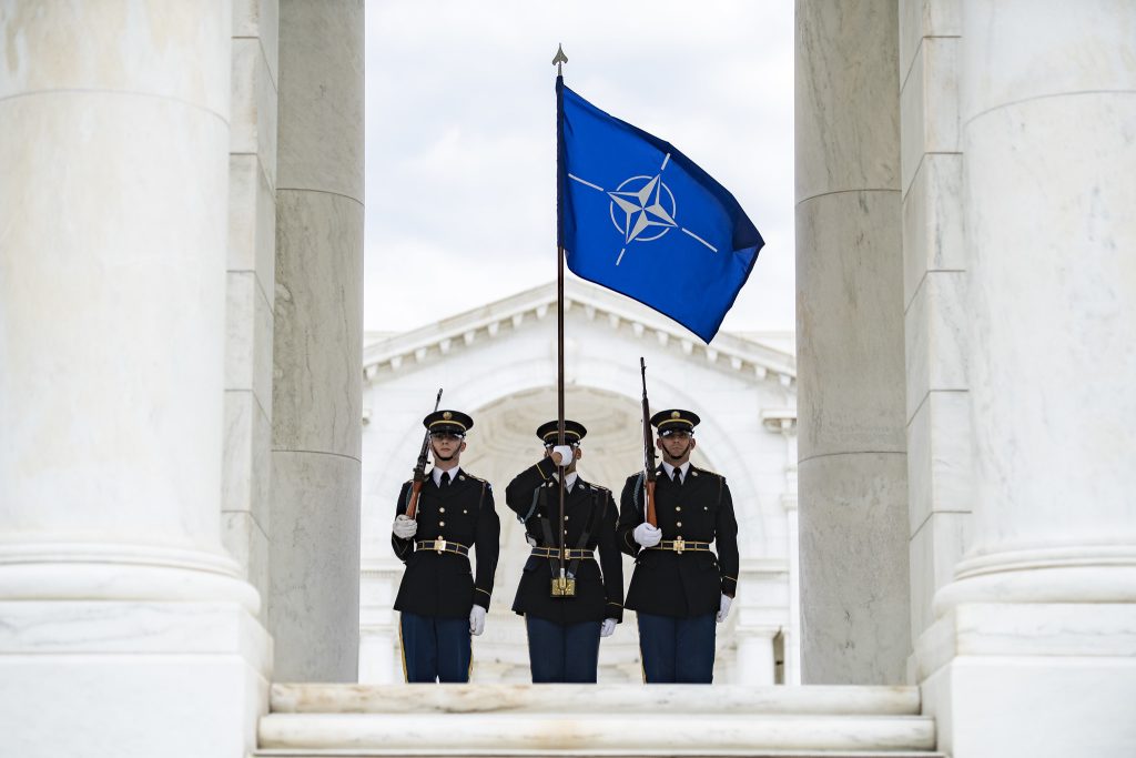Photo: A color guard from the 3rd US Infantry Regiment (The Old Guard) carry the NATO flag during an Army Full Honors Wreath-Laying Ceremony at the Tomb of the Unknown Soldier at Arlington National Cemetery, Arlington, Va., April 17, 2023. Credit: Elizabeth Fraser / Arlington National Cemetery / US Army.