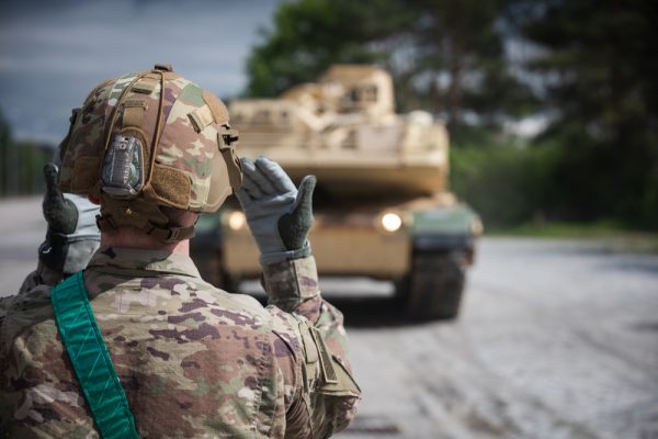 Photo: GRAFENWOEHR, Germany – A U.S. Army Soldier assigned to 2nd Armored Brigade Combat Team, 1st Infantry Division, directs the delivery of U.S. M1A1 Abrams tanks needed for training the Armed Forces of Ukraine at Grafenwoehr, Germany, May 12, 2023. The M1A1 training is expected to last several weeks. The 7th Army Training Command will facilitate the training at Grafenwoehr and Hohenfels training areas in Germany on behalf of U.S. Army Europe and Africa. Credit: U.S. Army photo by Spc. Adrian Greenwood via dvids https://www.dvidshub.net/image/7817280/m1a1-tanks-arrive-grafenwoehr