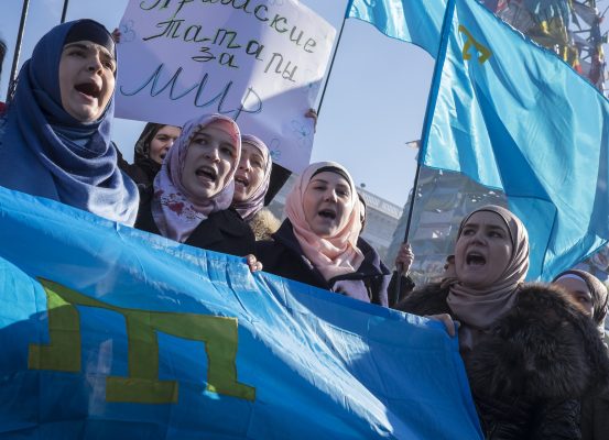 Photo: Crimean Tatars flags and shout slogans during an anti-war rally at Independence Square in Kiev March 8, 2014. A convoy of hundreds of Russian soldiers in about 50 troop trucks drove into a base near Crimea's capital Simferopol on Saturday, a Reuters reporting team in the Russian-occupied Ukrainian province said. Credit: REUTERS/Gleb Garanich (UKRAINE - Tags: POLITICS CIVIL UNREST)