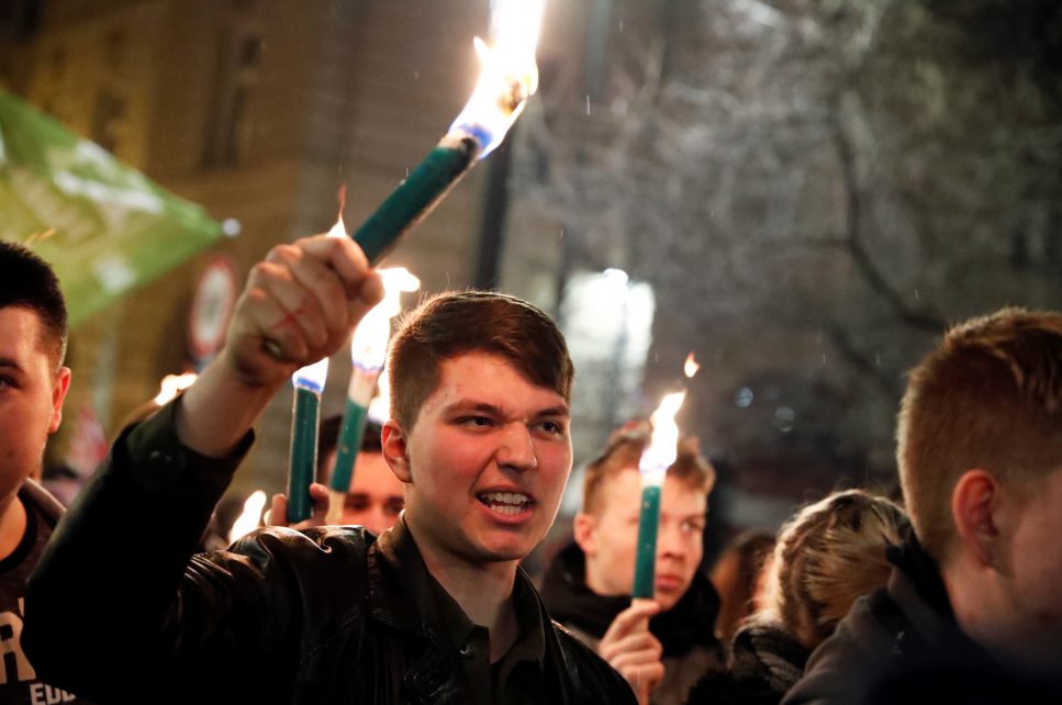 Photo: A member of a nationalist group holds a torch during a march to commemorate the 100th anniversary of Miklos Horthy's election in Budapest, Hungary March 1, 2020. Credit: REUTERS/Bernadett Szabo
