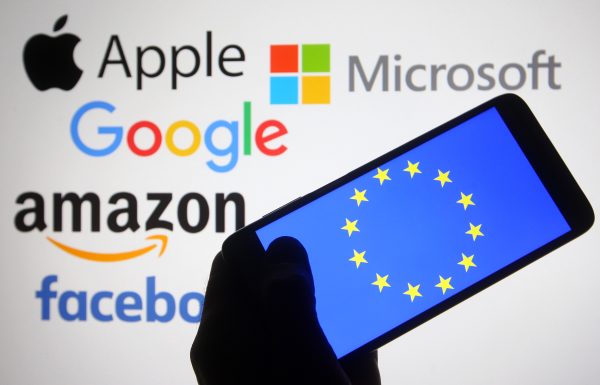 Photo: In this photo illustration, the EU (European Union) flag is seen on a smartphone screen in front of Apple, Microsoft, Google, Amazon and Facebook logos. Credit: Pavlo Gonchar / SOPA Images/Sipa USA