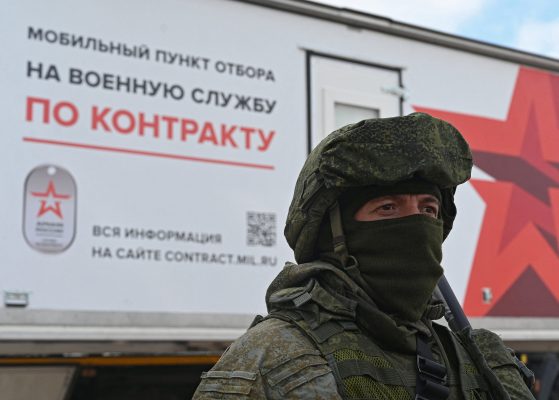 Photo: A Russian service member stands next to a mobile recruitment center for military service under contract in Rostov-on-Don, Russia September 17, 2022. Credit: REUTERS/Sergey Pivovarov