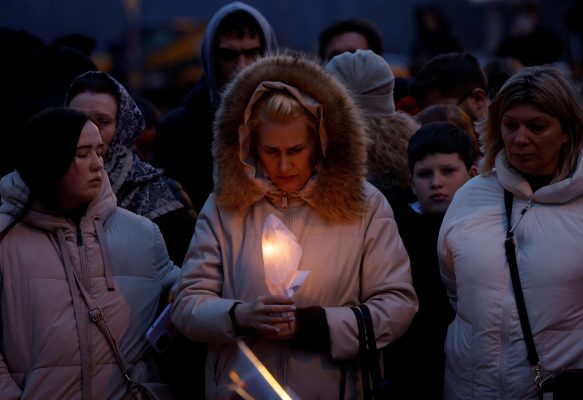Photo: A woman holds a candle in front of a makeshift memorial to the victims of a shooting attack set up outside the Crocus City Hall concert venue in the Moscow Region, Russia, March 23, 2024. Credit: REUTERS/Maxim Shemetov