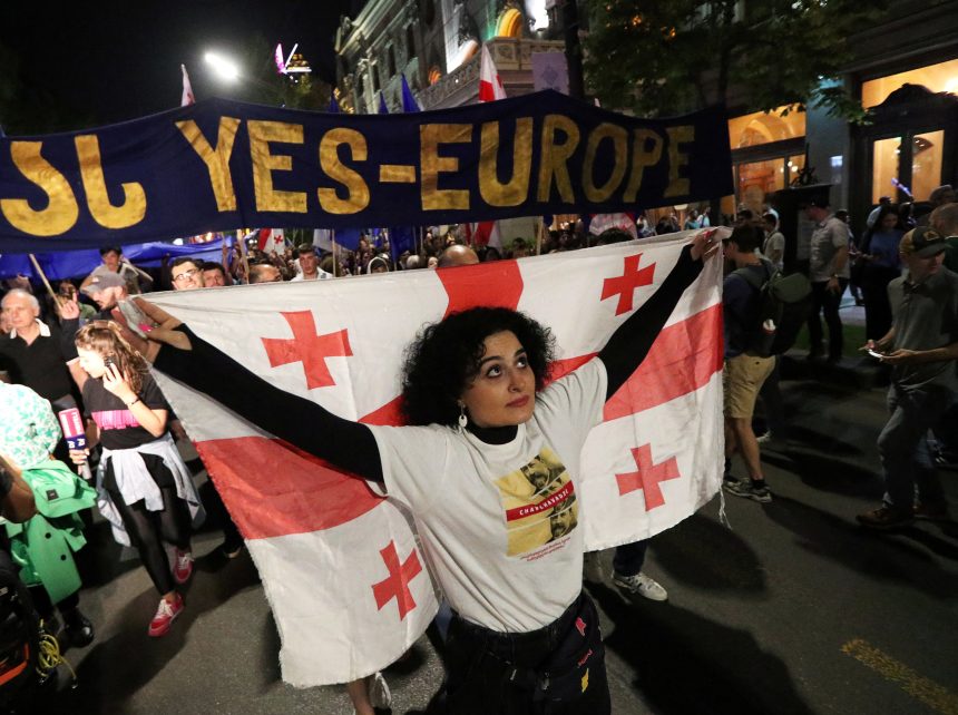 Photo: A demonstrator carries a Georgian flag during a protest against a bill on "foreign agents" in Tbilisi, Georgia April 28, 2024. Credit: REUTERS/Irakli Gedenidze.