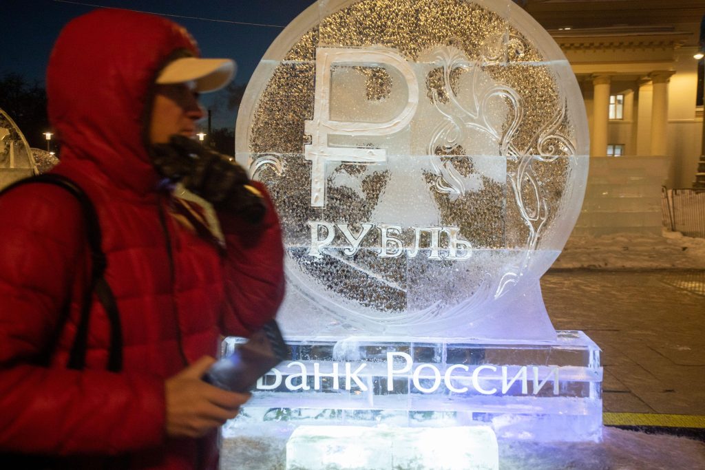 Photo: Moscow, Russia. 13th of January, 2024. An ice sculpture in a form of a ruble coin of the Bank of Russia is installed at the Central Entrance to VDNH in Moscow, Russia. Credit: Nikolay Vinokurov / Alamy Stock Photo.