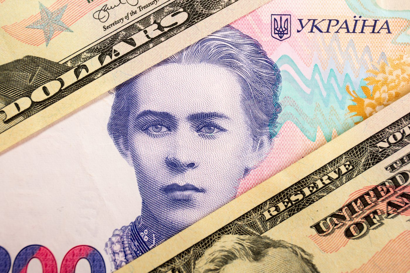 Photo: In this photo illustration, United States 50 dollar bills and 200 Ukrainian Hryvnias banknote with the image of Lesya Ukrainka are seen displayed. Credit: Karol Serewis / SOPA Images/Sipa USA via Reuters connect