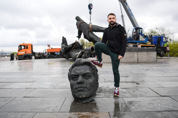 Photo: A man poses for photos while stepping on the dismantled Soviet Union monument. On April 25, 2022, Kyiv mayor Vitali Klitschko announced the removal of the Soviet Union monument in Central Kyiv. This monument erected in 1982 as a symbol of the reunification of Ukraine and Russia during the Soviet government era. The statue of two men holding a medal represents the Soviet Union's Order of Friendship of Peoples, while the rainbow-like arch is called The People's Friendship Arch. Additionally, some streets linked to Russia would be renamed. Credit: Salvatore Cavalli / SOPA Images/Sipa USA