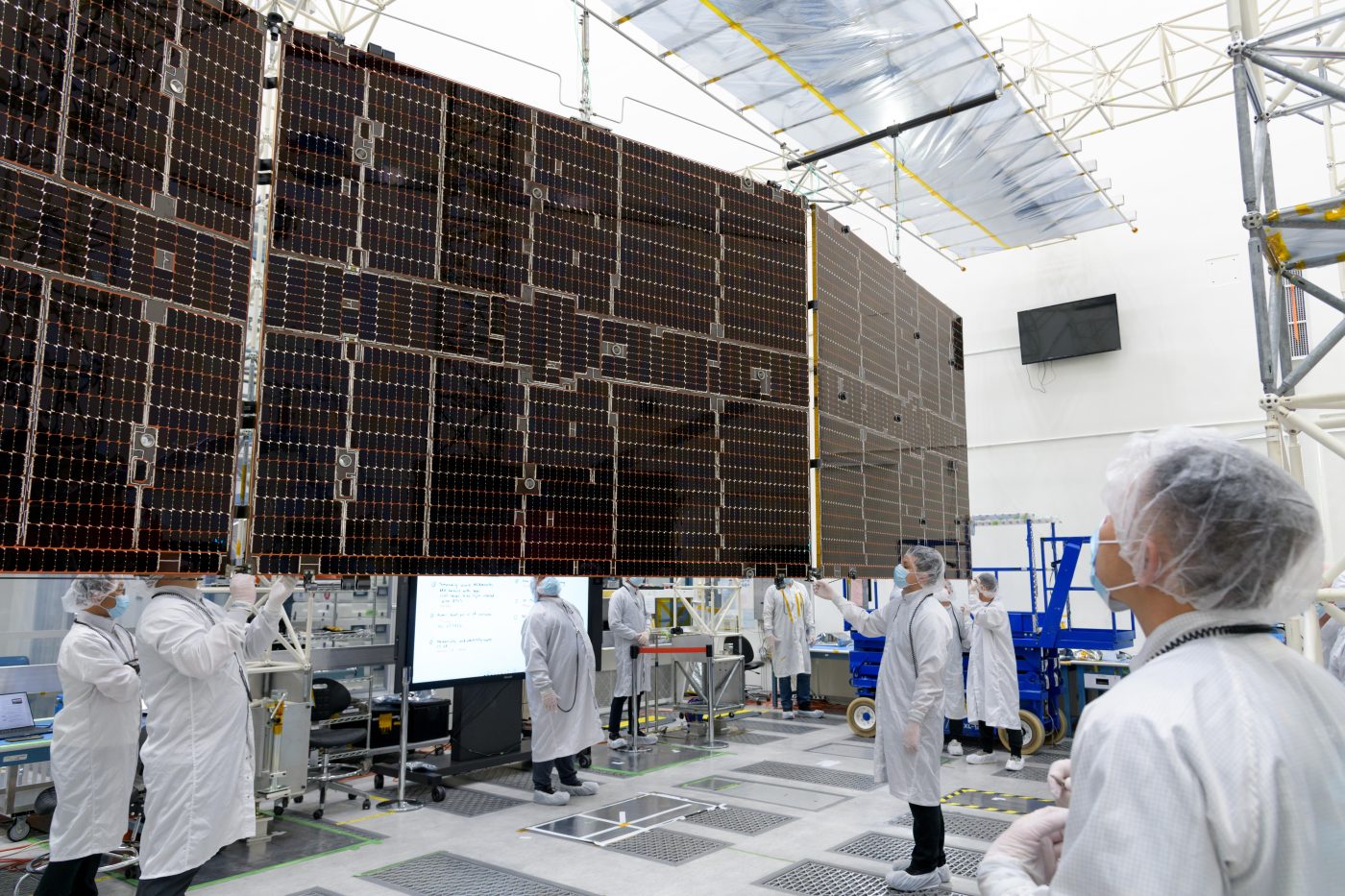Photo: Engineers at NASA's Jet Propulsion Laboratory in Southern California examine one of Psyche's solar arrays during a deployment test in the Lab's High Bay 2 clean room in late February 2022. Credit: NASA/JPL-Caltech https://photojournal.jpl.nasa.gov/catalog/PIA25134