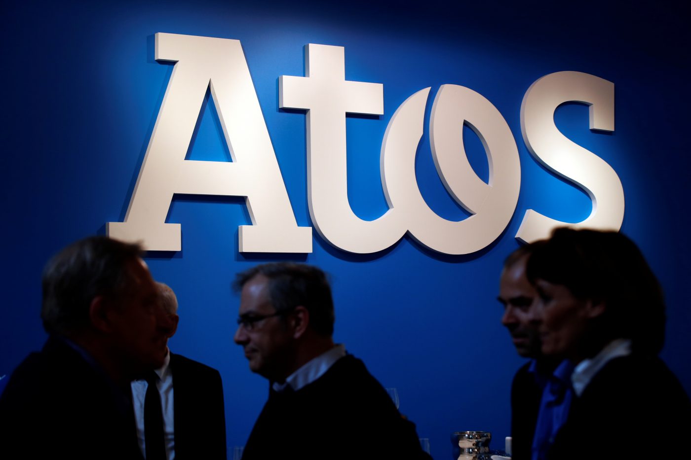 Photo: People walk in front of Atos company's logo during a presentation of the new Bull sequana supercomputer in Paris, France, April 12, 2016. Credit: REUTERS/Philippe Wojazer
