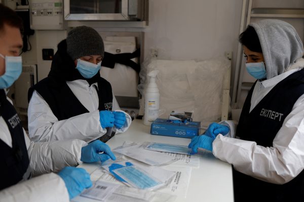 Photo: Lab staff work inside a mobile DNA laboratory run by the Ukrainian Prosecutor Generals Office provided by the government of France from the Gendarmerie Scientifique to take DNA samples to match families with bodies found in a mass grave, in Izium, Kharkiv region, Ukraine, November 2, 2022. The Hague-based International Commission on Missing Persons, an intergovernmental organization, estimates that more than 15,000 people have gone missing across Ukraine during the war, including detainees, those separated from their loved ones and people killed and buried in makeshift graves. Credit: REUTERS/Clodagh Kilcoyne