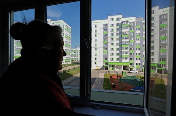 Photo: Local resident Valentina Ryabokrys, 85, looks out of a window in her new apartment, which she received from the Russian-installed authorities to replace her house destroyed in the course of Russia-Ukraine conflict, in the city of Mariupol, Russian-controlled Ukraine, September 26, 2023. Credit: REUTERS/Alexander Ermochenko