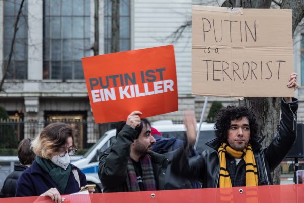 Photo: Protesters hold placards saying, "Putin is a killer" and "Putin is a terrorist" at a makeshift memorial and protest in front of the Russian embassy in Berlin following the death of Russian opposition leader Alexey Navalny. Credit: Nicholas Muller / SOPA Images via Reuters Connect