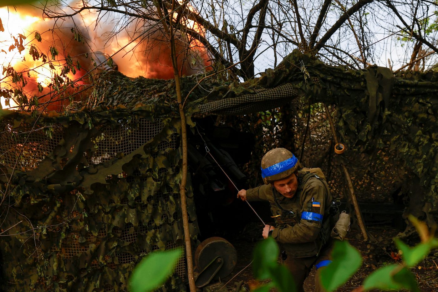 Photo: Ukrainian soldier Ivan Liashko, service member of the 13th Operative Purpose Brigade 'Khartiia' of the National Guard of Ukraine and a D-20 howitzer crew commander, fires towards Russian troops, amid Russia's attack on Ukriane, in a front line in Kharkiv Region, Ukraine May 21, 2024. Credit: REUTERS/Valentyn Ogirenko
