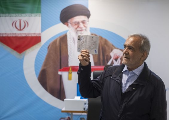 Photo: Iranian reformist lawmaker, Masoud Pezeshkian, is holding up his identification while standing in front of a banner featuring a portrait of Iran's Supreme Leader Ayatollah Ali Khamenei as he attends a registration hall in the Iranian Interior Ministry building to register as a presidential election candidate during the third day of candidates' registration for Iran's early presidential elections, in Tehran, Iran, on June 1, 2024. Credit: Morteza Nikoubazl/NurPhoto
