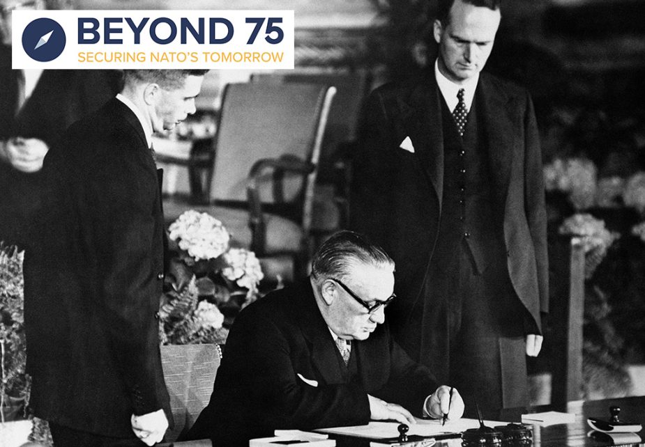 Photo: Ernest Bevin, Foreign Secretary, signing the North Atlantic Pact on behalf of Britain , in the auditorium of the United States Department in Washington. Looking on is Sir Oliver Franks (left), British Ambassador to the US. US President Harry Truman was also at the signing. Credit: PA Images via Reuters Connect