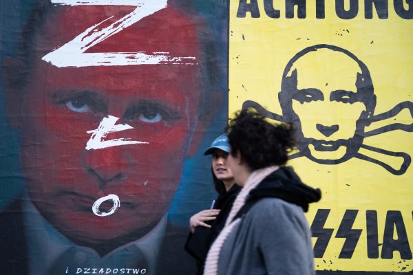 Photo: People walks past of anti-Putin posters in Warsaw, Poland, on March 21, 2022. Credit: Annabelle Chih/NurPhoto