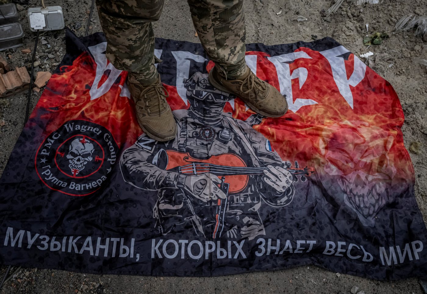 Photo: A Ukrainian serviceman stands on a flag of Russia's mercenary group Wagner, amid Russia's attack on Ukraine, near the Russian border in Sumy region, Ukraine August 13, 2024. Credit: REUTERS/Viacheslav Ratynskyi/File Photo