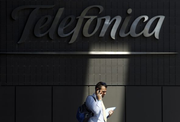 Photo: A man talks on his cell phone outside Telefonica headquarters in Madrid July 29, 2010. Telefonica posted a robust 9.4 percent rise in first-half profit as strength abroad offset a weak, but improving, performance at home, affirming the logic of its Vivo deal in fast-growing Brazil. Investors on Thursday focused on the modest signs of improvement at Telefonica's recession-hit Spanish unit, following its long-awaited deal, announced on Wednesday, to buy control of Brazilian mobile unit Vivo. Credit: REUTERS/Susana Vera