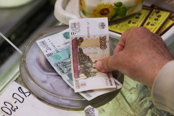 Photo: A customer pays with Russian ruble banknotes at a market in Saint Petersburg, Russia July 9, 2023. Credit: REUTERS/Anton Vaganov